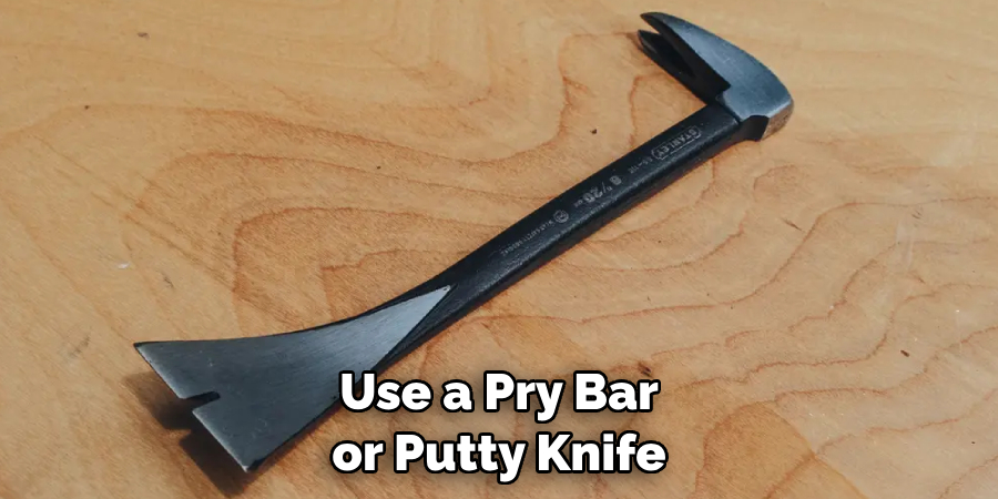 Use a Pry Bar or Putty Knife