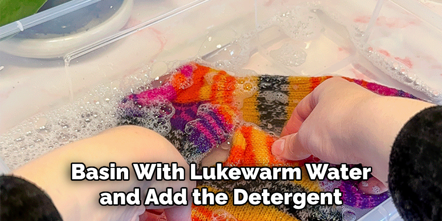 Basin With Lukewarm Water and Add the Detergent 