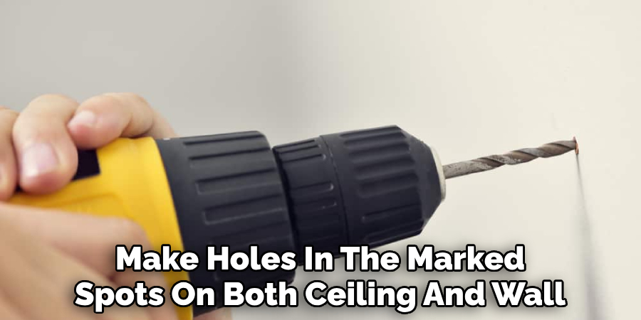 Make Holes In The Marked Spots On Both The Ceiling And Wall