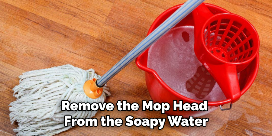 Remove the Mop Head From the Soapy Water