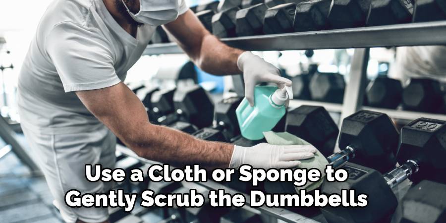 Use a Cloth or Sponge to Gently Scrub the Dumbbells
