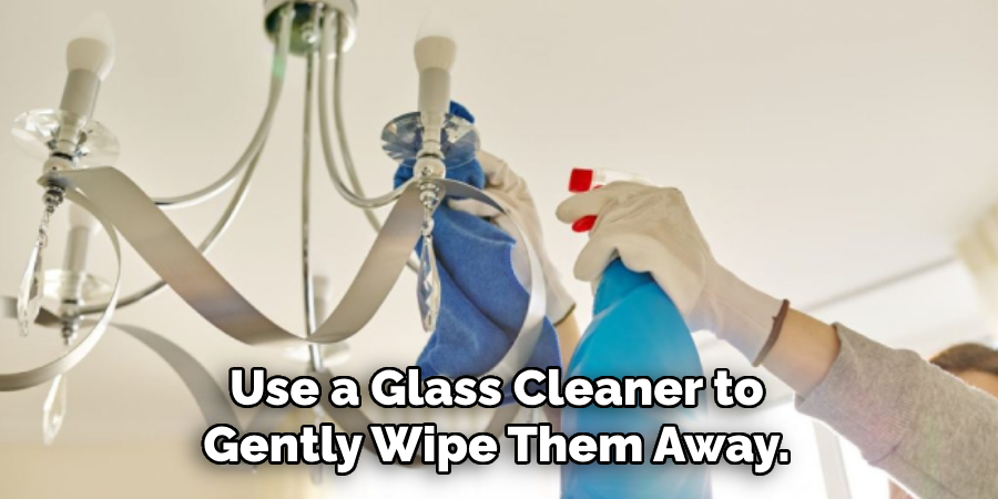 Use a Glass Cleaner to Gently Wipe Them Away.