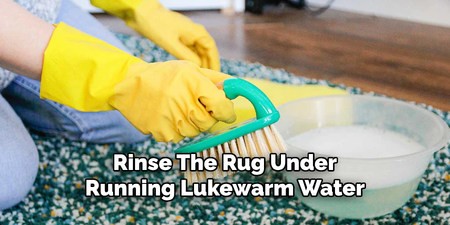 Rinse the Rug Under Running Lukewarm Water