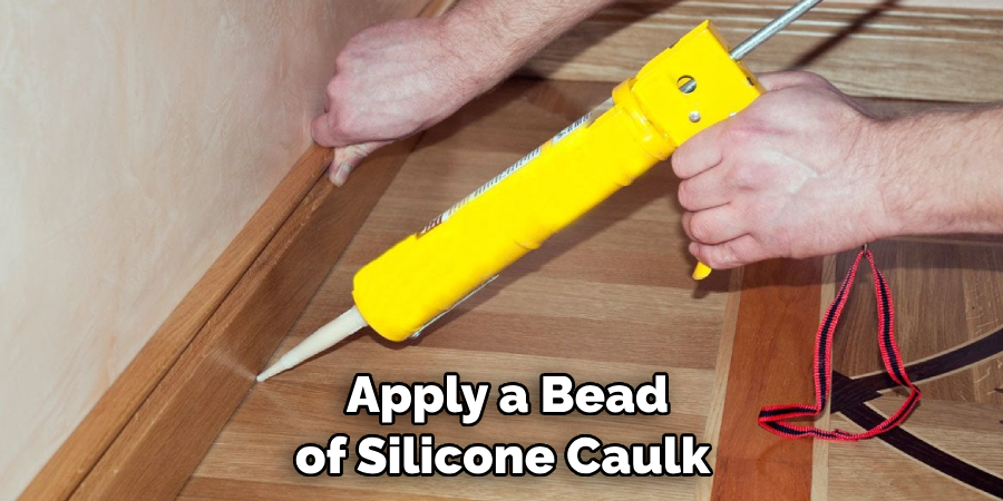 apply a bead of silicone caulk