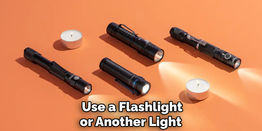Use a Flashlight or Another Light 